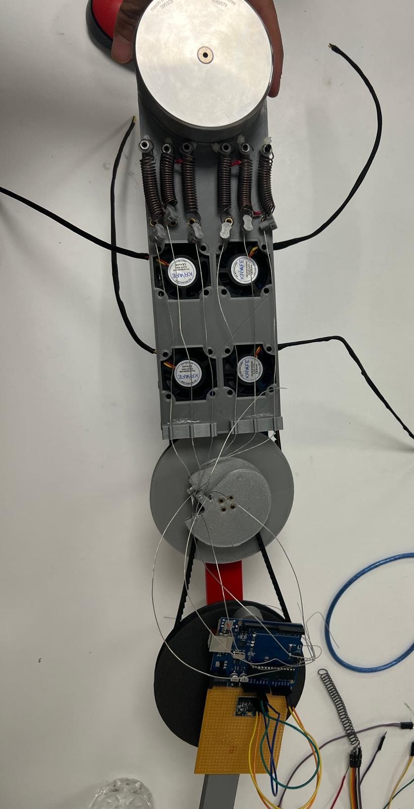 Prototype of the variable-stiffness actuator, showing the motor, pulleys and shape-memory-alloy springs wired to a controller board.